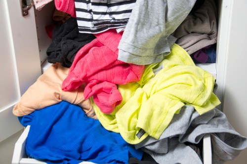 Operatives wearing high-visibility PPE and securing waste containers for transport